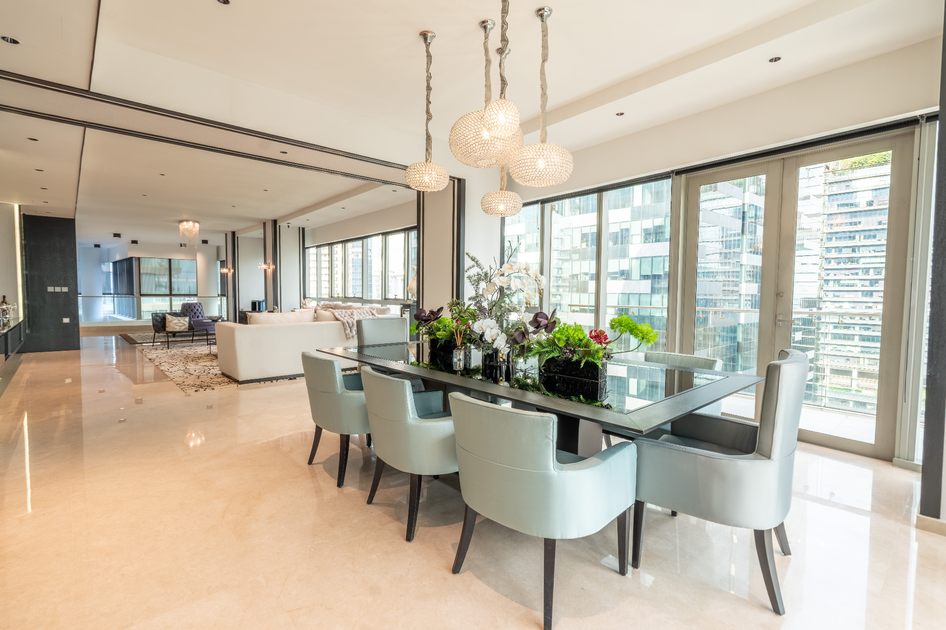 Elegant dining area with full-height glazing and skyline outlook