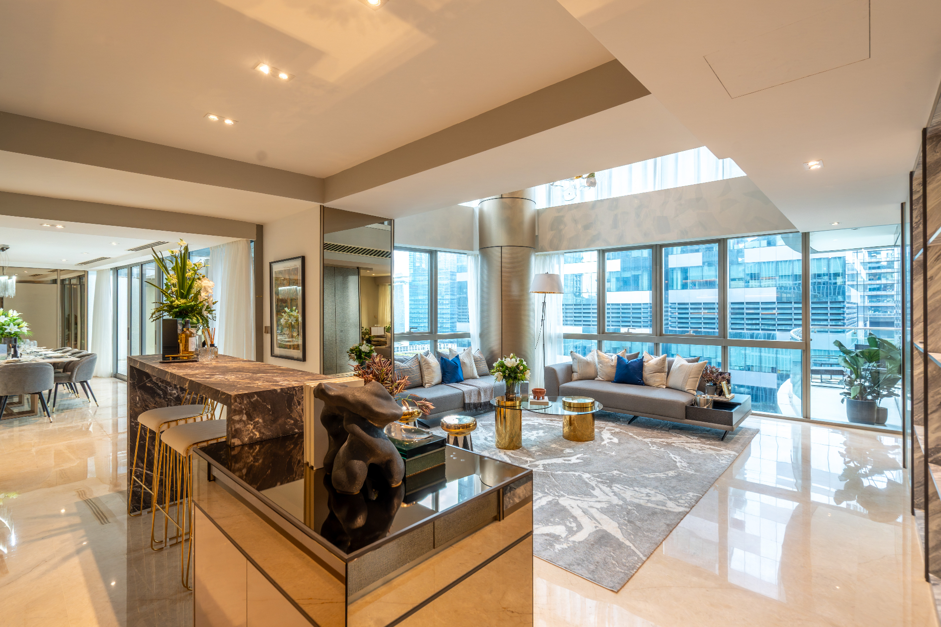 Open living and dining area with marble finishes and city outlook